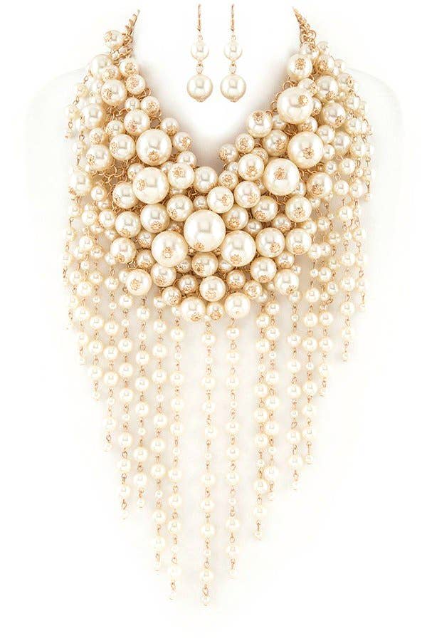 Multiple layers of pearl necklaces on a white background